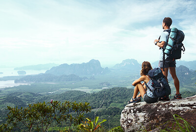 Couple at the top of a mountain looking out